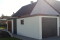 STAHL-Einzelgarage mit Sektionaltor und Anbau-Carport hinten als Holzliege - BRANDL